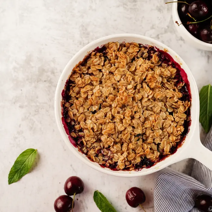 cherry crisp in a white bowl